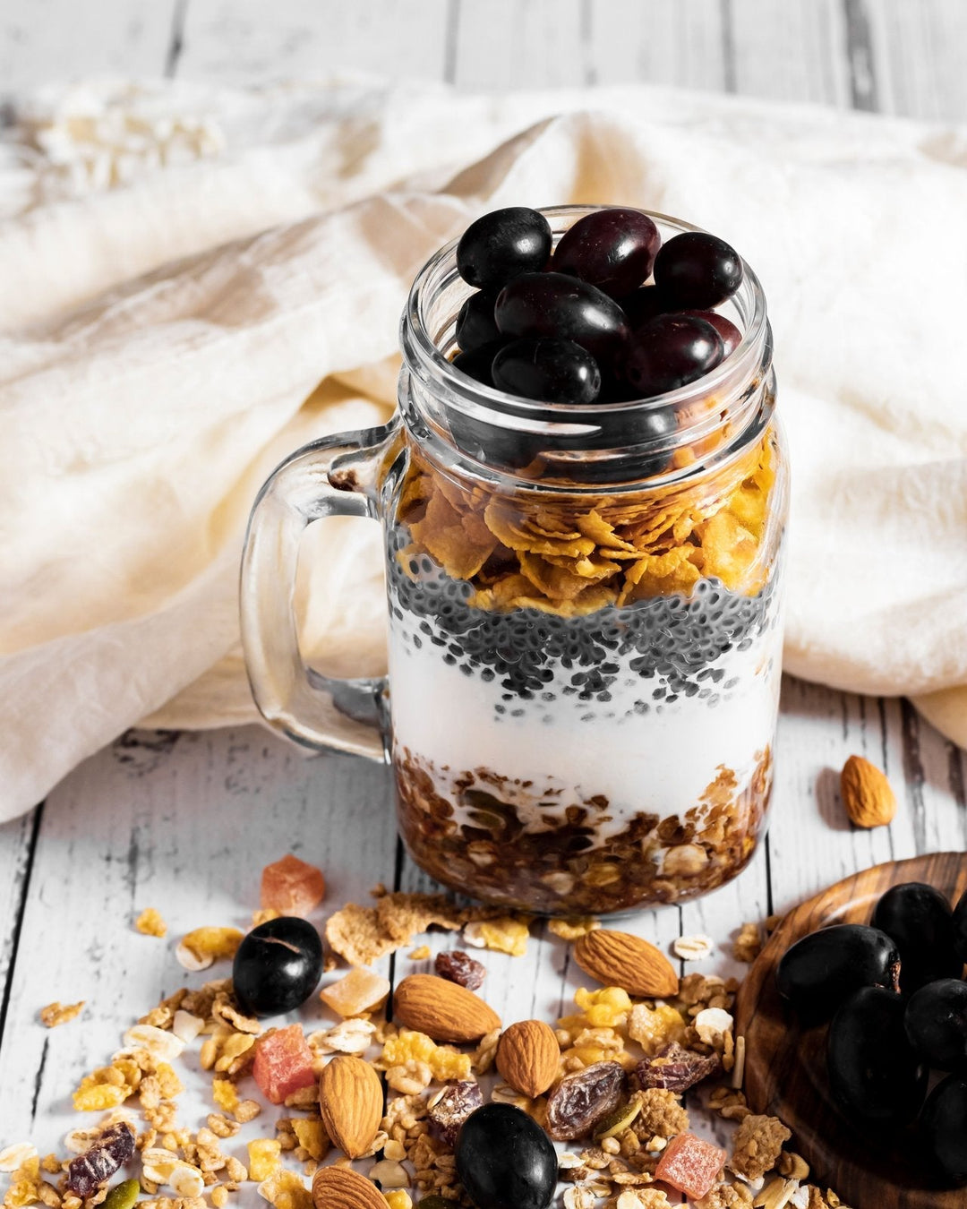 Bulk organic granola with almonds and dried fruit in a mason jar, back-to-school breakfast idea
