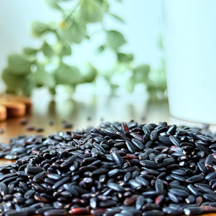Organic black rice grains close-up image, displaying their natural sheen and dense color, ideal for wholesome, nutrient-rich cooking