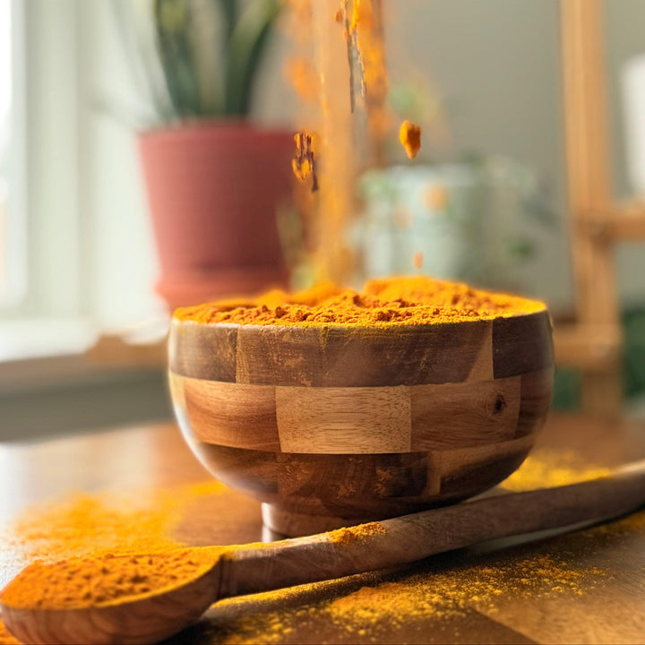 Purely Organic Foods turmeric powder, USDA-certified organic and non-GMO, captured in a rustic kitchen setting for cooking and spice rack aesthetics."