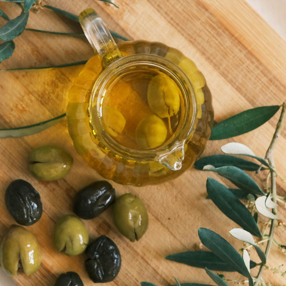 Cold-pressed organic EVOO from Purely Organic Foods, packaged in a dark glass bottle to preserve flavor and nutrients, perfect for everyday culinary use."

"Organic extra virgin olive oil captured in a rustic kitchen setting, highlighting its rich texture and natural clarity, ideal for Mediterranean-style cooking."

"High-quality organic olive oil, extra virgin and cold-pressed, displayed on a countertop with ingredients, emphasizing its use in dressings, marinades, and dips."